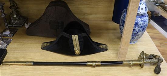 A Whiteman & Woolwich Outfitter's Naval sword and bi-corn with box sword 94cm